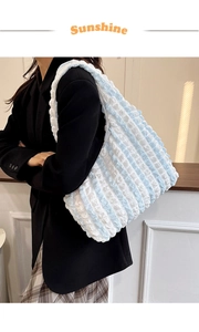 Detail of blue and white striped bubble tote bag featuring popcorn texture fabric