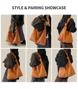 Vue détaillée du sac cabas en daim marron avec motifs floraux découpés au laser et nœud