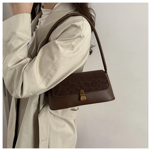 Detail of leopard print suede and brown leather texture with vintage gold metal buckle