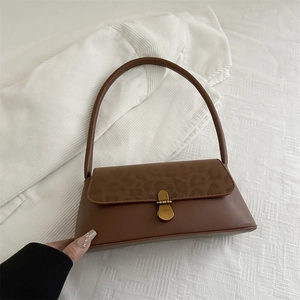 Retro leopard print underarm bag in dark brown leather with golden metallic buckle closure