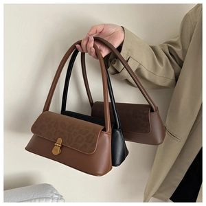 Detailed comparison of leopard print and solid baguette bags with vintage metal locks