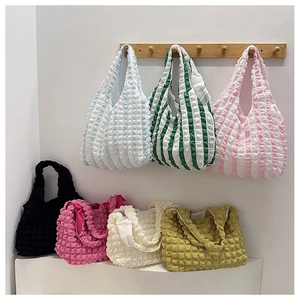 Detailed view of large capacity bubble texture tote bags in various vibrant colors
