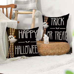 Detail of Halloween throw pillow covers with Trick or Treat and Ghost prints on linen