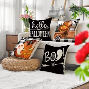 Four Halloween pillow covers with pumpkin and ghost prints on a cozy cream sofa