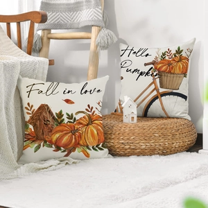 Detail of linen pumpkin pillow covers with Hello Pumpkin text on cozy home decor background