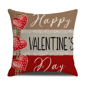 Detail of linen Valentine's Day pillow cover with red hearts and holiday greetings