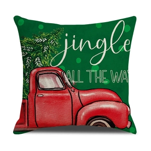 Close-up of linen Christmas pillow cover with vintage red truck and green tree pattern