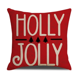 Close-up of red linen Christmas pillow cover with Holly Jolly text and tree print