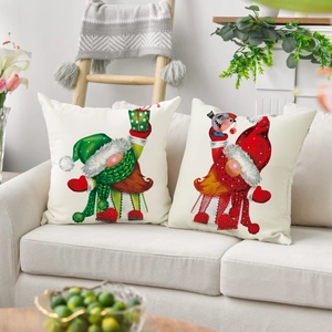 Set of two Christmas gnome pillow covers in linen fabric on a modern white sofa