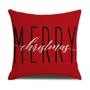 Detail of red linen Christmas pillow cover with Merry Christmas print and fabric texture