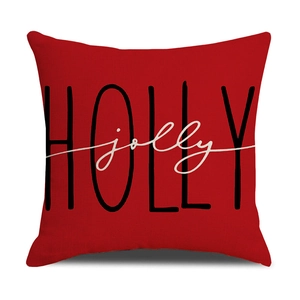 Detailed view of red linen Christmas pillowcase with HOLLY jolly printed festive text