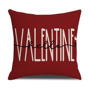 Detail of red Valentine pillowcase with white typography and black hello script on linen