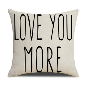 Close-up of linen fabric texture with Love You More script on a red heart pillowcase