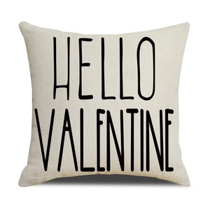 Close-up of beige linen pillowcase texture with black HELLO VALENTINE print