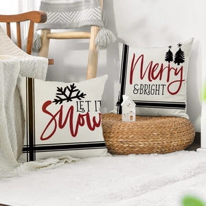 Close-up of linen Christmas pillow covers with Let It Snow and Merry & Bright printing