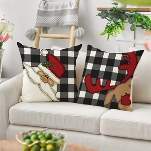 Christmas buffalo plaid pillow covers with Santa and reindeer on a beige sofa