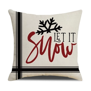 Detailed texture of linen pillowcase featuring Let It Snow text and snowflake patterns