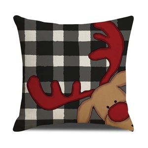 Detail of Christmas buffalo plaid pillowcase with cute reindeer graphic and linen texture