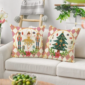 Set of two linen Christmas pillows with Nutcracker and festive tree on cream sofa