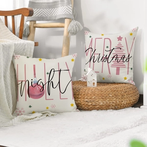 Close-up of linen Christmas pillows with pink ornaments and Merry Christmas text