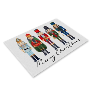 Detail of Christmas table mat featuring watercolor nutcracker print and Merry Christmas text