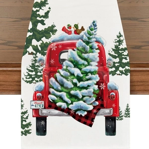 Detail of Christmas table runner with retro red truck and snowy pine trees design
