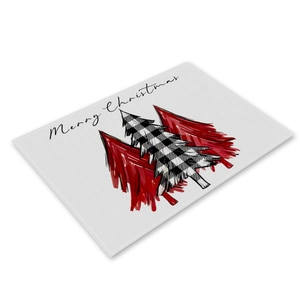 Detailed view of linen Christmas placemat with buffalo plaid tree and Merry Christmas text
