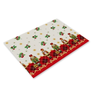 Detail of linen Christmas placemat with nutcracker design and red black plaid border