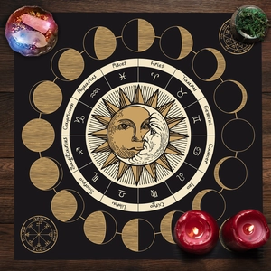 Detail of black altar cloth showing sun moon phase cycle and zodiac signs on wood background
