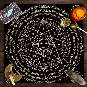Detail of velvet altar cloth with gold sun mandala and mystical ritual crystals on wood