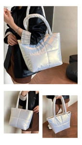 Close-up of quilted silver puffer tote bag showing glossy texture and padded handle