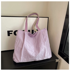 Detail of light purple large tote bag with pleated nylon fabric and durable dual straps