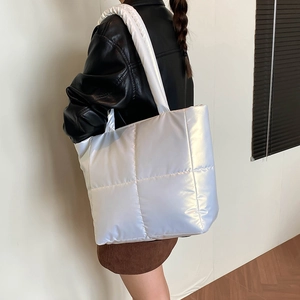 Chic white quilted puffer tote bag with metallic finish and wide shoulder strap