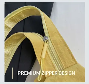Macro shot of bright yellow nylon fabric texture and sleek zipper detail on chest bag