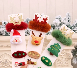 Close-up of festive Christmas hair accessory set on display card with Santa and reindeer motifs