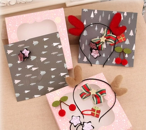 Detail of Christmas reindeer antler headbands with striped bows and glitter star accents