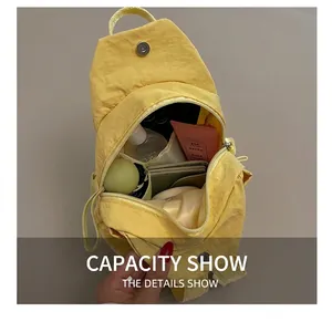 Interior view of yellow nylon sling bag showing large capacity for personal essentials