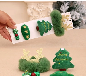 Detailed view of Christmas hair accessories set including tree clip and reindeer scrunchie