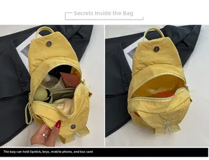 Detail view of the spacious main compartment showing interior storage of yellow nylon bag