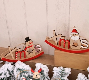 Close-up of wooden Xmas rocking ornaments with Santa and Snowman holiday designs