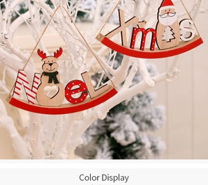 Close-up of wooden Christmas ornaments with NOEL and Xmas signs on white branches