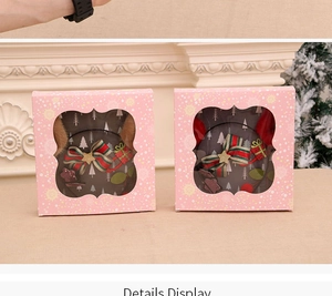 Detailed view of Christmas headband gift boxes featuring reindeer antlers and striped bows