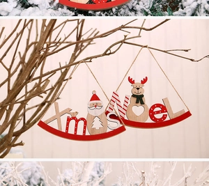 Detail of wooden Xmas and Noel hanging ornaments with Santa and reindeer designs