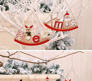 Detail of wooden Noel and Xmas hanging ornaments with reindeer and Santa patterns