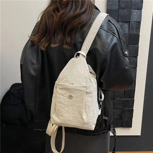 Minimalist cream nylon crossbody chest bag with adjustable strap and metallic logo