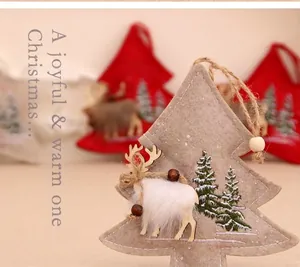 Detail of felt Christmas tree ornament with reindeer embroidery and hemp rope hanger
