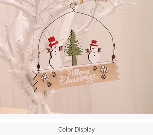 Detail of a Merry Christmas wooden hanging sign with snowman and tree on white branch