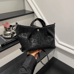 Chic black leopard pattern tote bag with glossy finish and detachable shoulder strap