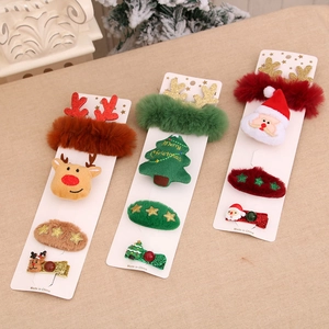 Christmas gift set featuring festive plush hair clips with Santa and reindeer motifs