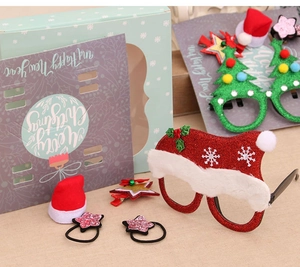 Detail of Christmas gift set featuring glitter glasses and hair accessories in a box